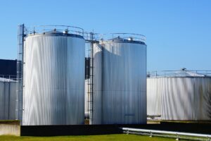 storage tanks with blue sky behind